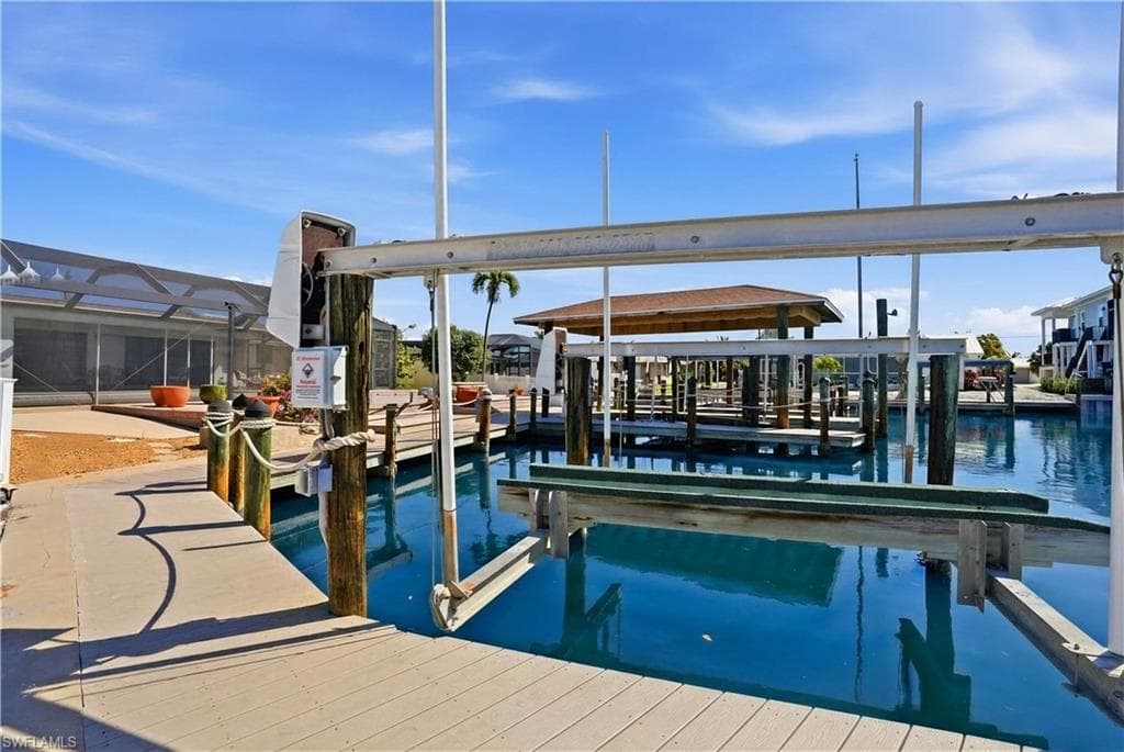 Private dock with boat lift, composite decking, and direct water access - Virtually Edited Image