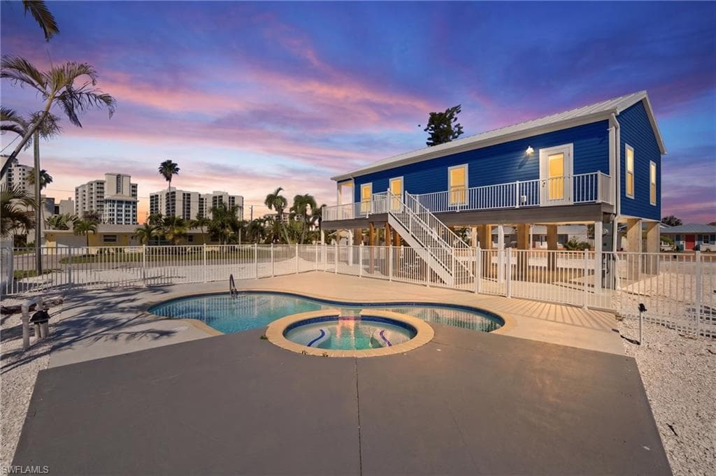 Elevated blue exterior with white trim and a metal roof - Virtually Edited Image