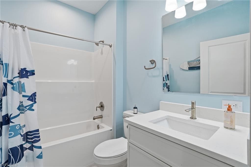 Full bathroom featuring a white vanity with integrated sink, brushed nickel faucet, and a wall-mounted mirror - Virtually Edited Image