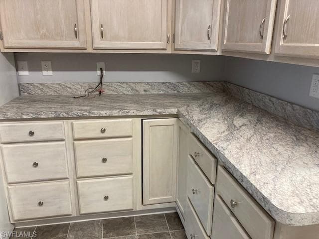 Kitchen featuring light brown cabinetry and light countertops