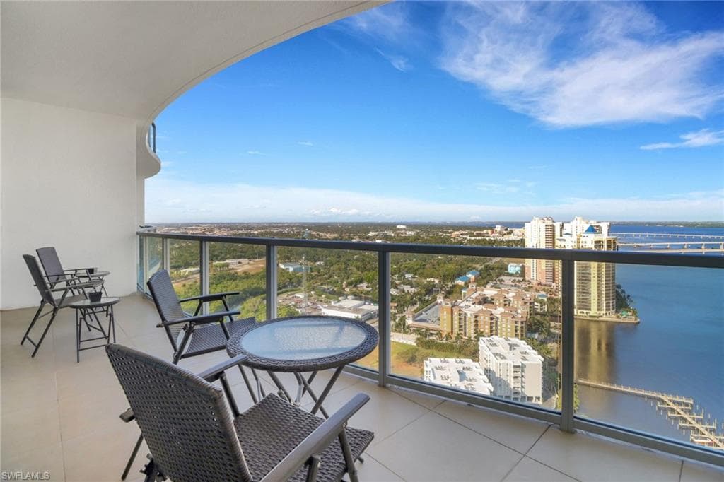 Balcony featuring river views and a views of city