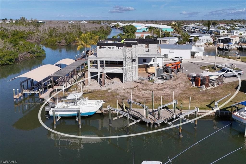 Dock featuring boat lift and a water view