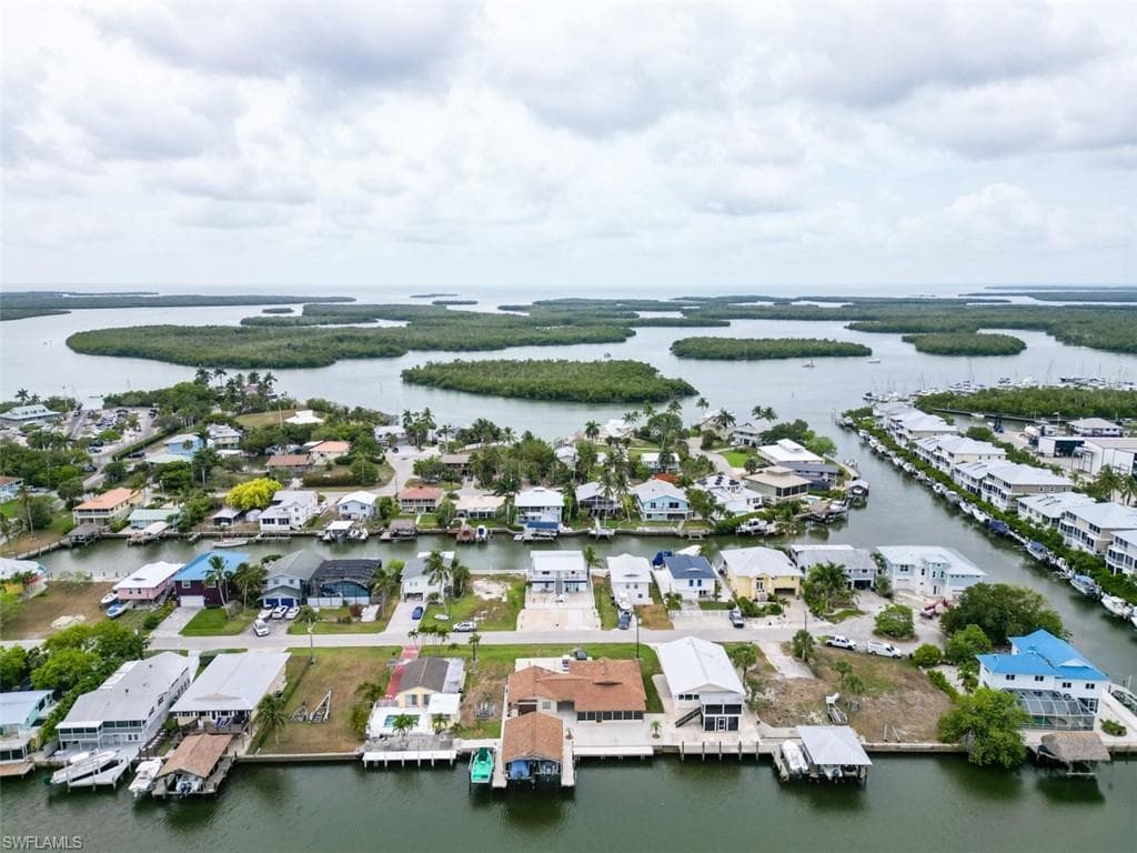 Aerial perspective of suburban area featuring a nearby body of water