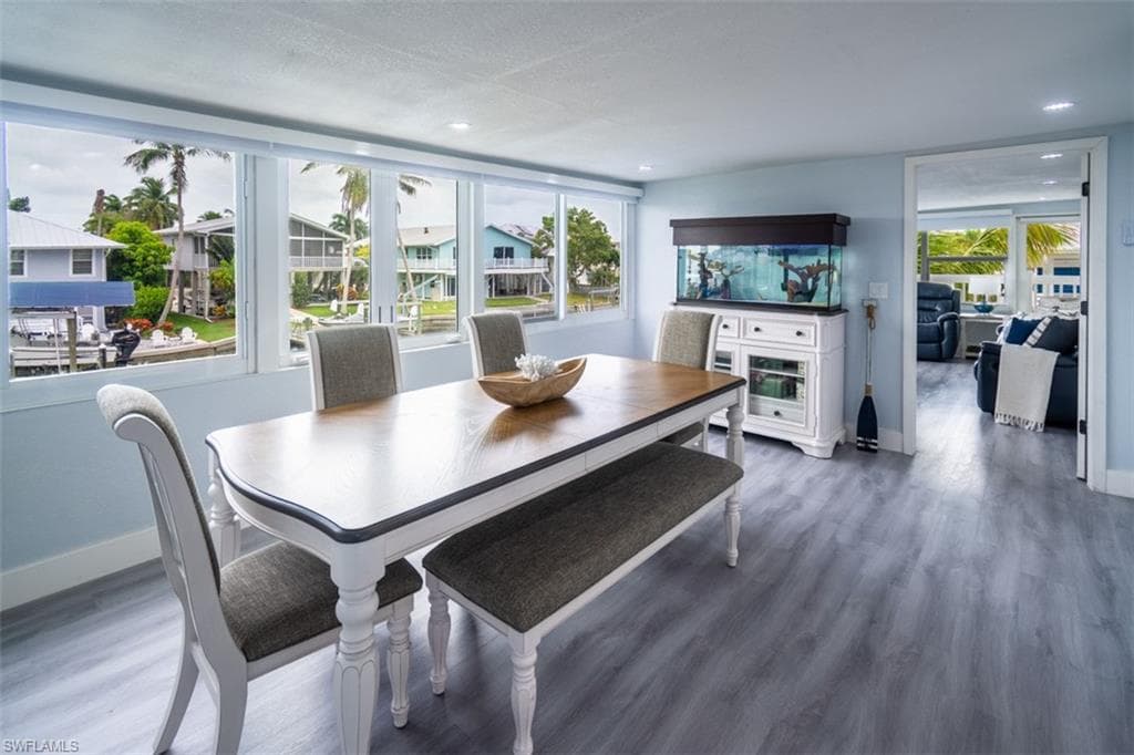 Dining space with wood finished floors and baseboards