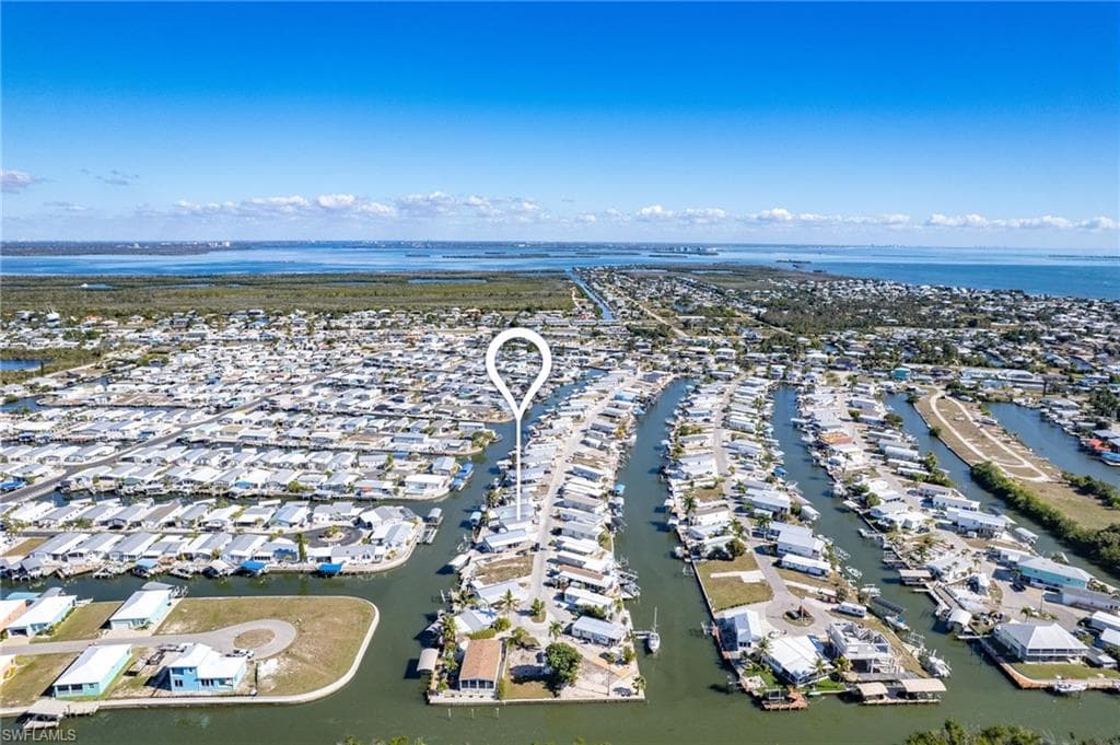 View of property location featuring a large body of water and nearby suburban area