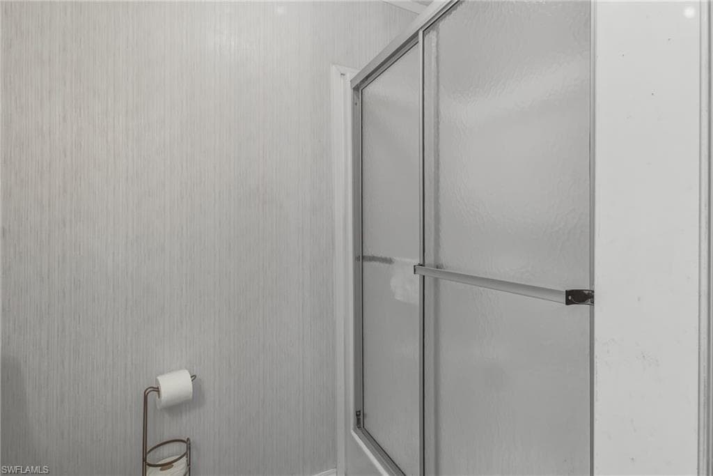 Full bathroom featuring a shower stall