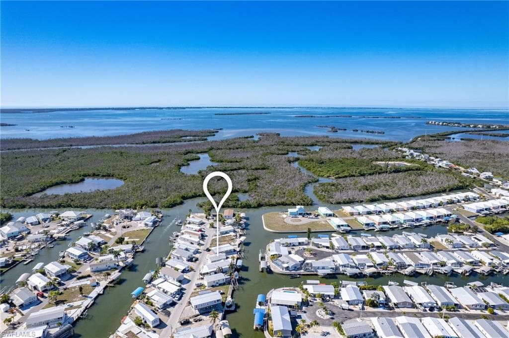 Aerial overview of property's location with a nearby body of water