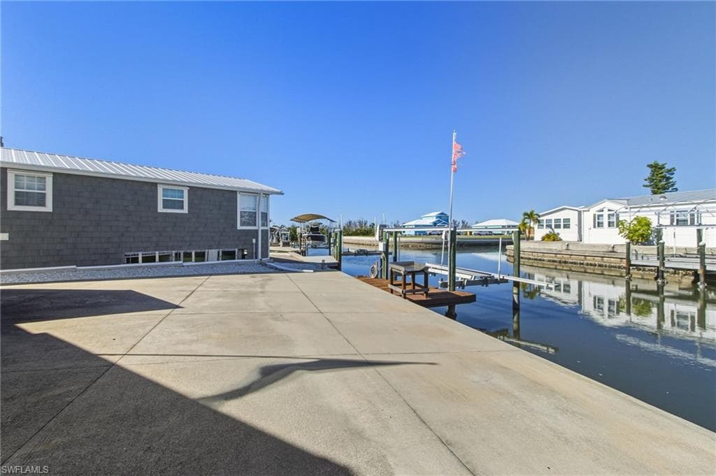Dock area with boat lift and a water view