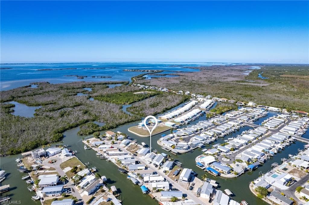 Aerial view of property's location with a large body of water
