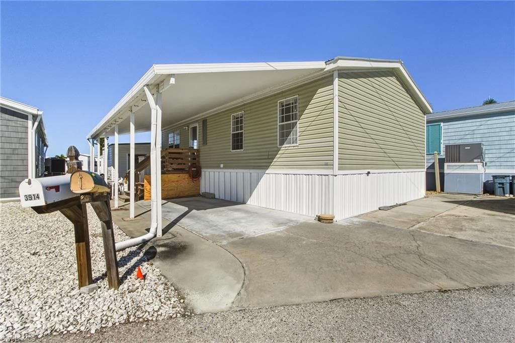 View of home's exterior with a carport and driveway