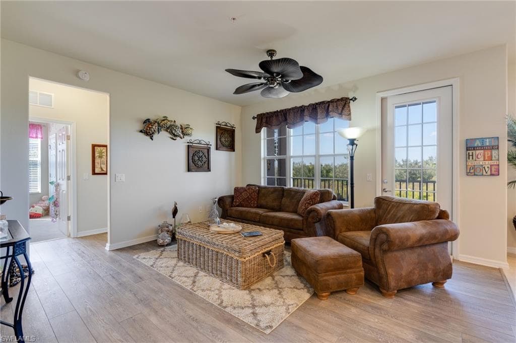 Living area featuring light wood-style flooring and a ceiling fan