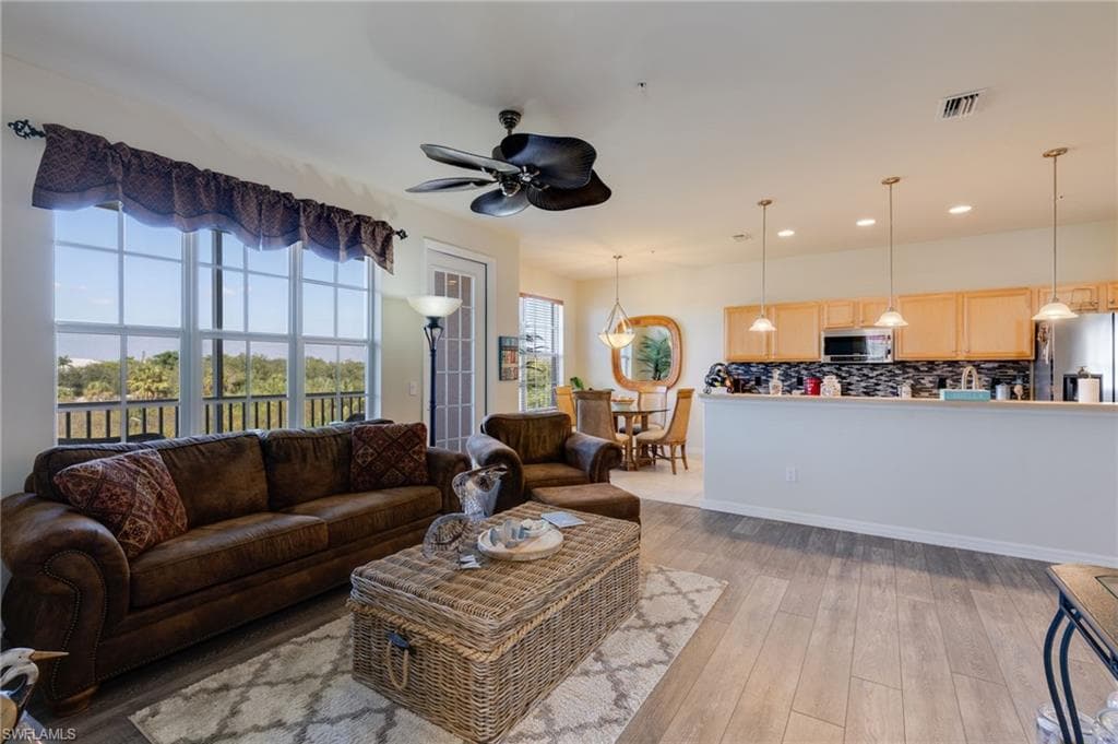 Living room featuring ceiling fan, light wood-style flooring, and recessed lighting