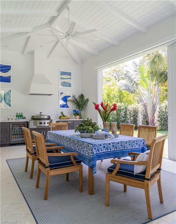 Dining area with beverage cooler, ceiling fan, and wood ceiling