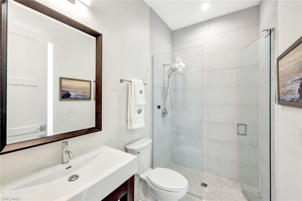 Bathroom featuring a stall shower and vanity