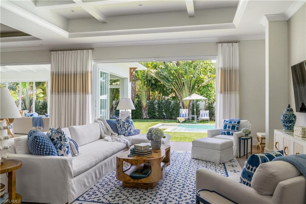 Living room featuring healthy amount of natural light, beam ceiling, and coffered ceiling