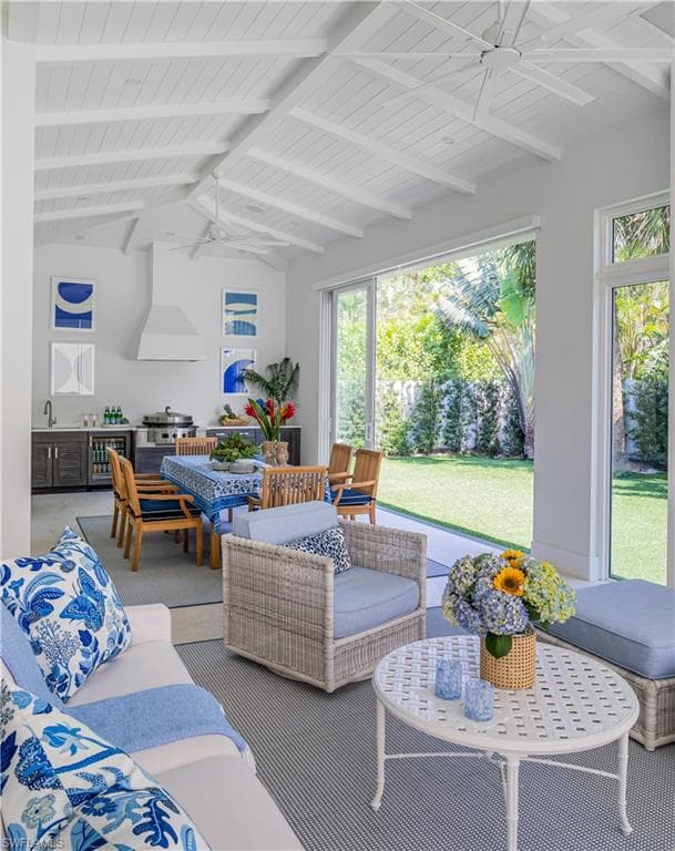 Sunroom / solarium featuring wine cooler and a sink