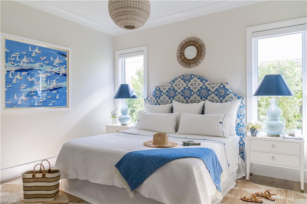 Bedroom with crown molding and wood finished floors