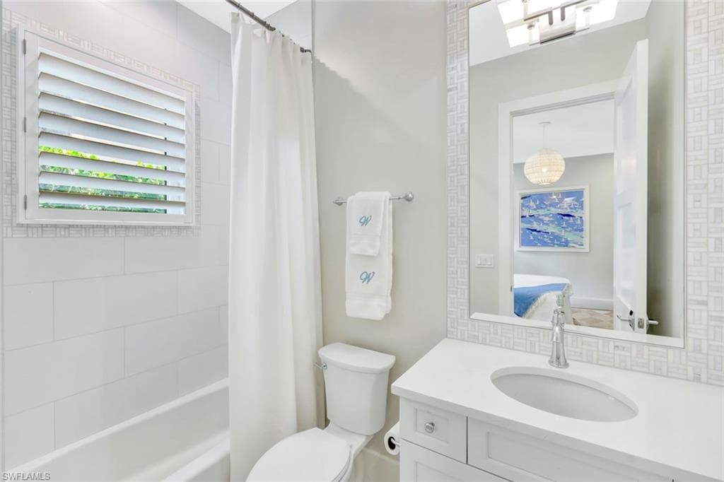 Ensuite bathroom featuring shower / bath combo and vanity