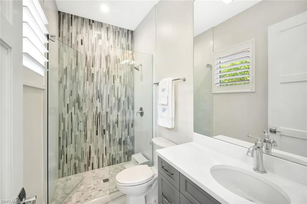 Full bath featuring vanity and a stall shower