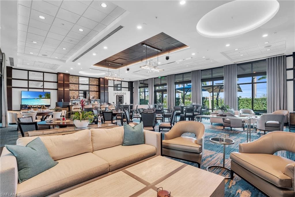 Community lobby featuring recessed lighting, a high ceiling, and expansive windows