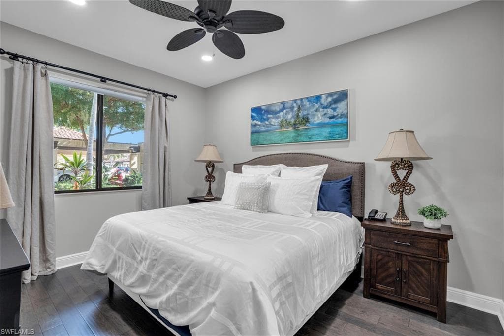 Bedroom with dark wood-style flooring, ceiling fan, and recessed lighting