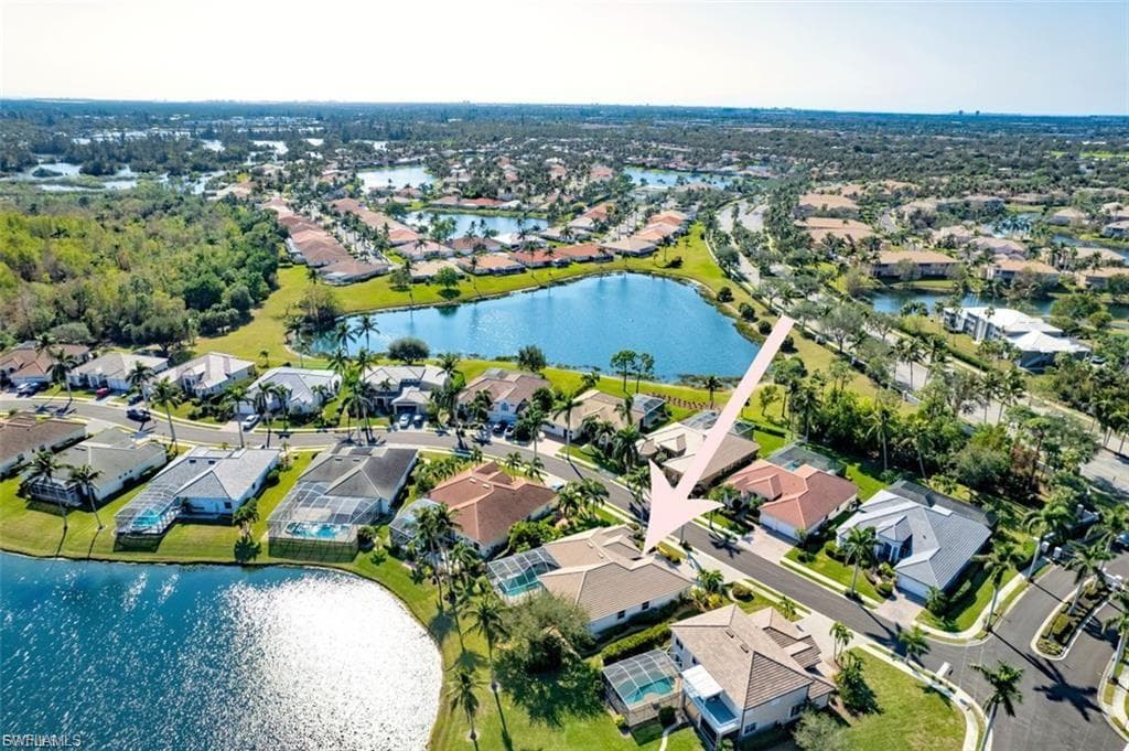 Aerial overview of property's location featuring a large body of water and nearby suburban area