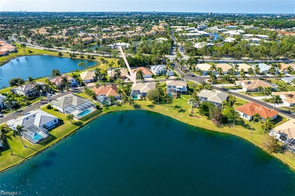 View of property location featuring a nearby body of water and nearby suburban area