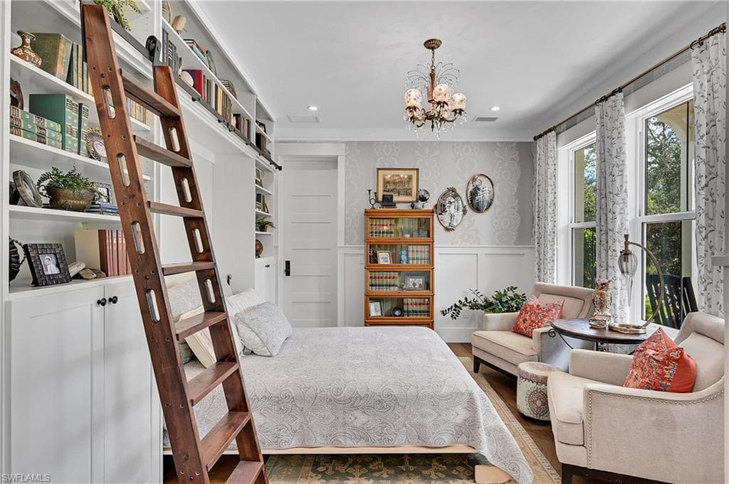 Charming library with custom built-in shelves, murphy bed, rolling ladder and elegant chandelier. Thoughtfully designed to serve as a cozy reading room or elegant guest room