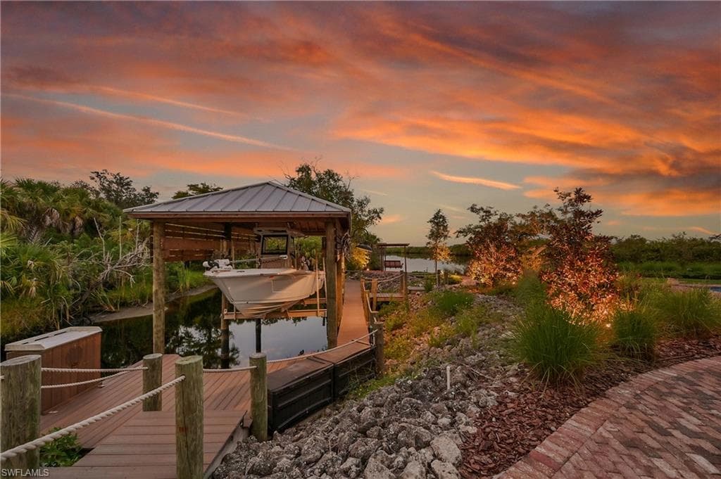 Private composite dock featuring a covered boat lift with room for 28 ft boat, fish cleaning station, and direct access to Deep Creek- perfect for boating and waterfront living
