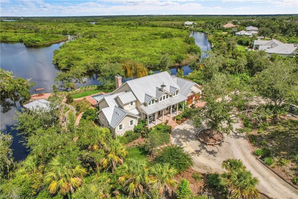 Sweeping aerial view of the estate along Deep Creek, offering protected preserve surroundings and a prime boating location just minutes from the open waters of the Peace River