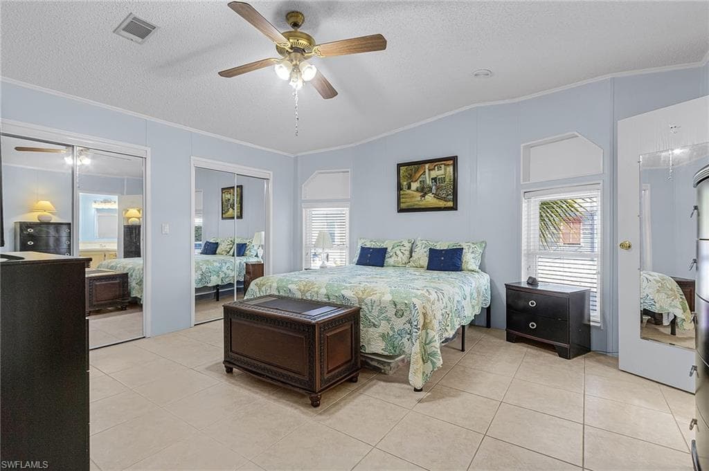 Primary Bedroom with a large room width walk-in closet.