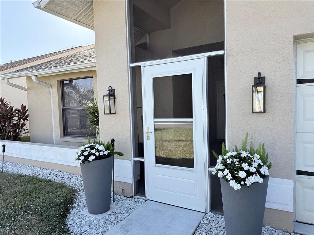 Entrance to property featuring stucco siding