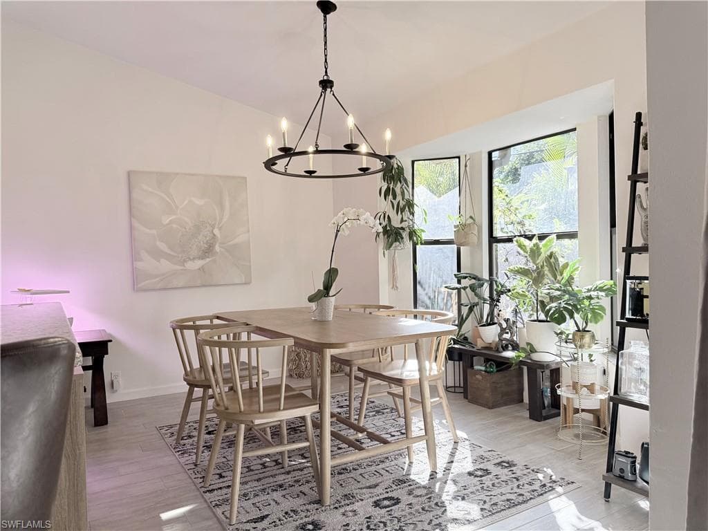 Dining area featuring light wood finished floors and a chandelier