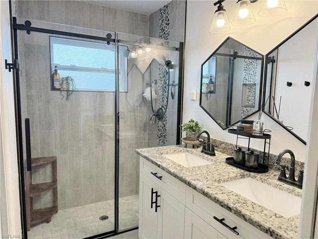 Full bath with a stall shower and double vanity