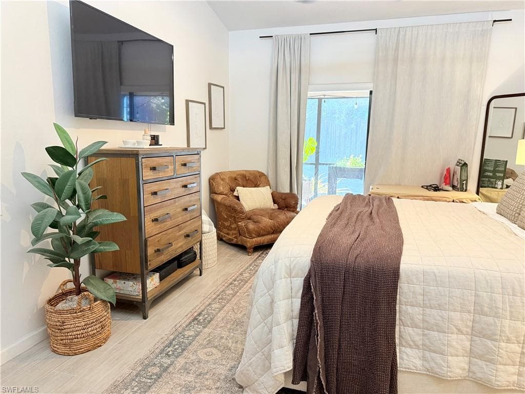 Bedroom featuring access to outside and light wood finished floors