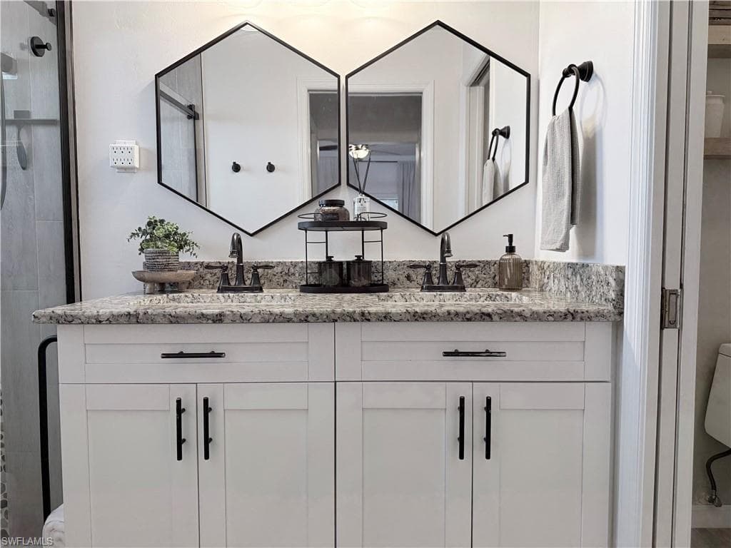 Bathroom with double vanity and a shower stall