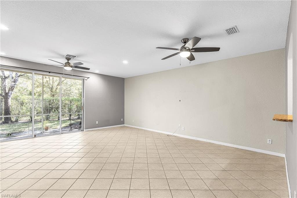 Unfurnished room with ceiling fan, recessed lighting, and light tile patterned floors