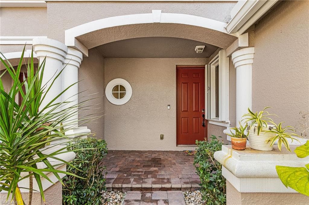 Entrance to property with stucco siding