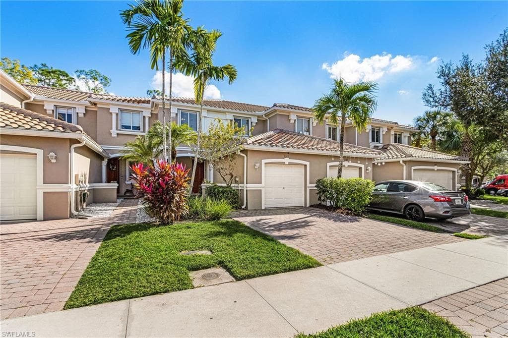Mediterranean / spanish home with stucco siding, decorative driveway, and a tiled roof