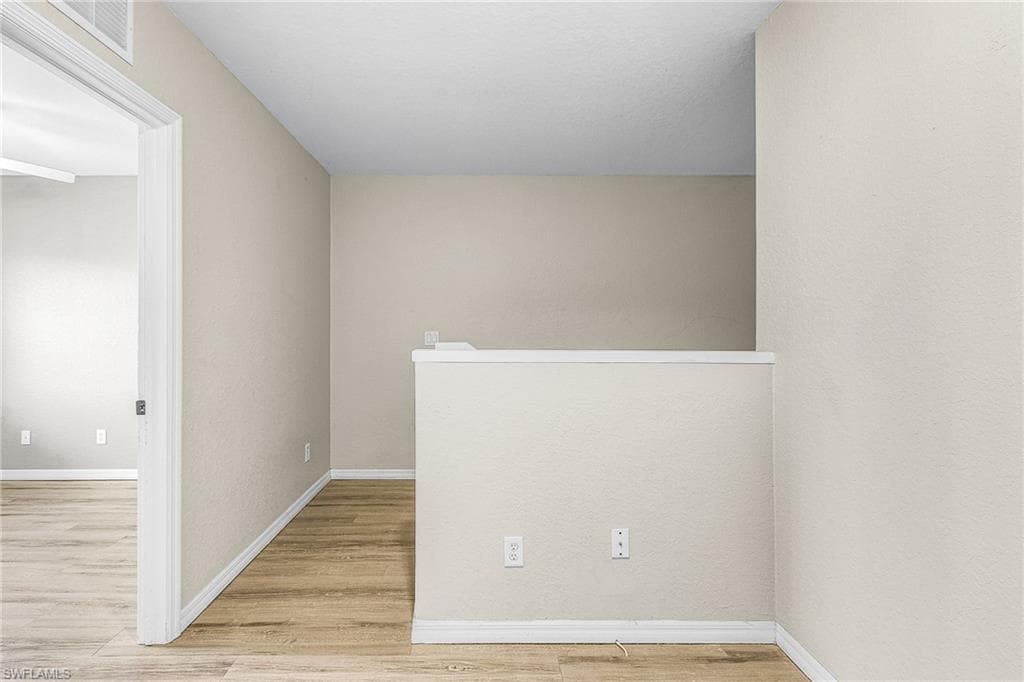 Unfurnished room featuring light wood-type flooring