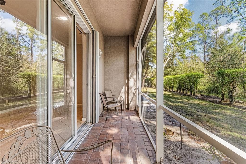 Unfurnished sunroom with brick flooring
