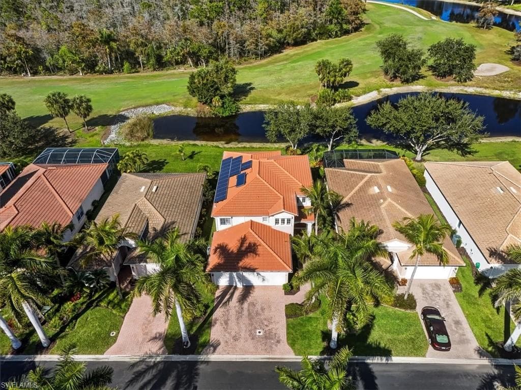 Aerial overview of property's location featuring a golf course and nearby suburban area