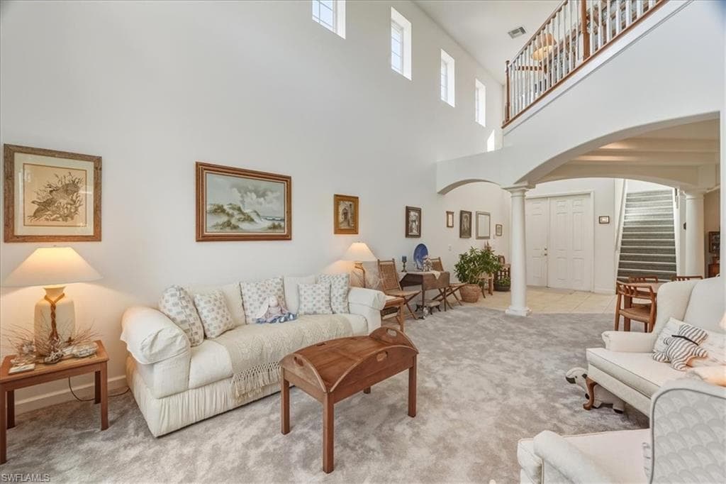 Mediterranean / spanish-style home with decorative driveway, a residential view, a front lawn, and a tile roof