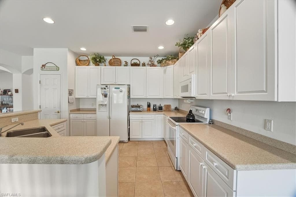 Living area with light tile patterned flooring and ceiling fan