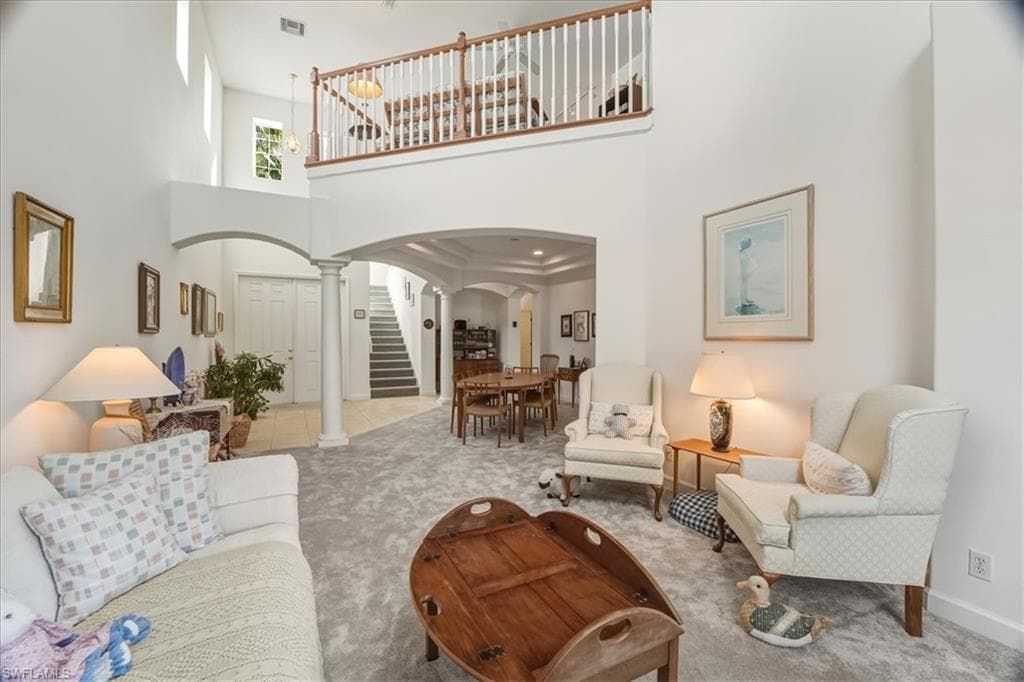 Living room with ceiling fan and light tile patterned floors