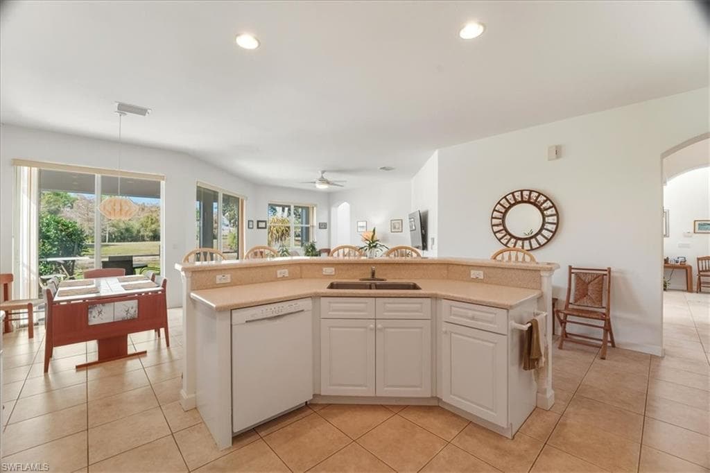 Dining space with light tile patterned floors and baseboards