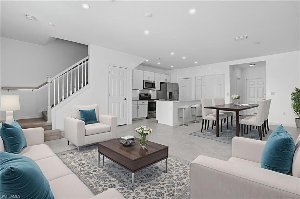 Living area with stairs and recessed lighting