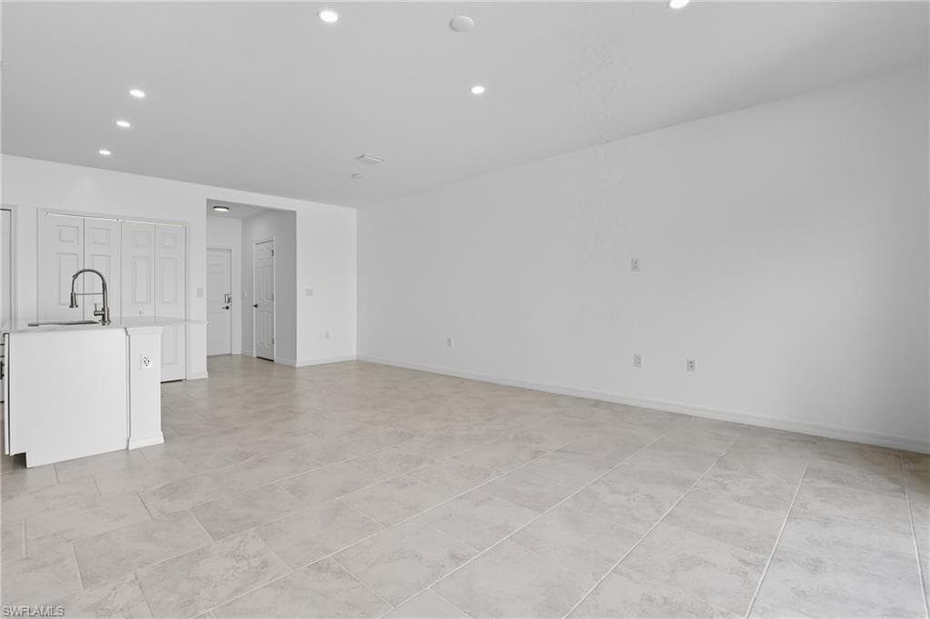 Unfurnished living room featuring recessed lighting