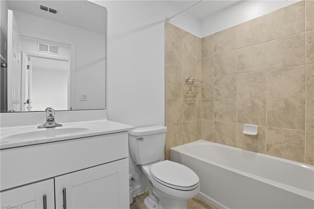 Full bathroom featuring shower / bath combination and vanity