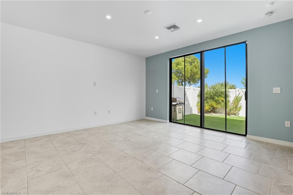 Empty room with recessed lighting and light tile patterned floors